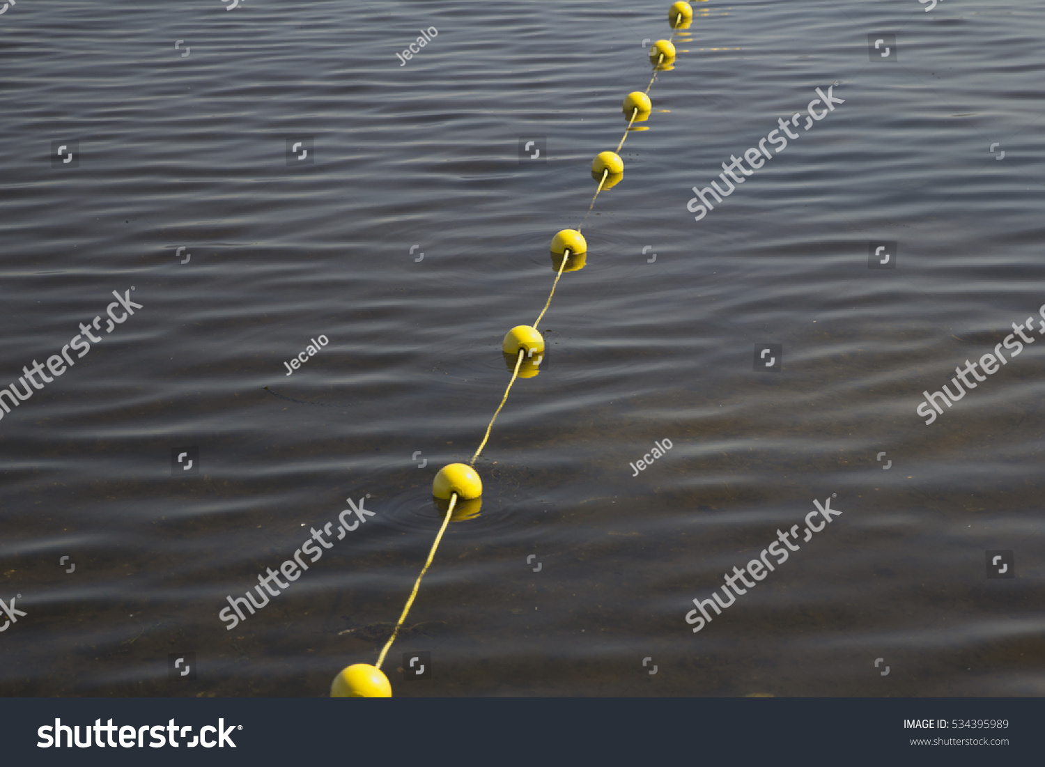 A yellow buoy line in the water. #534395989
