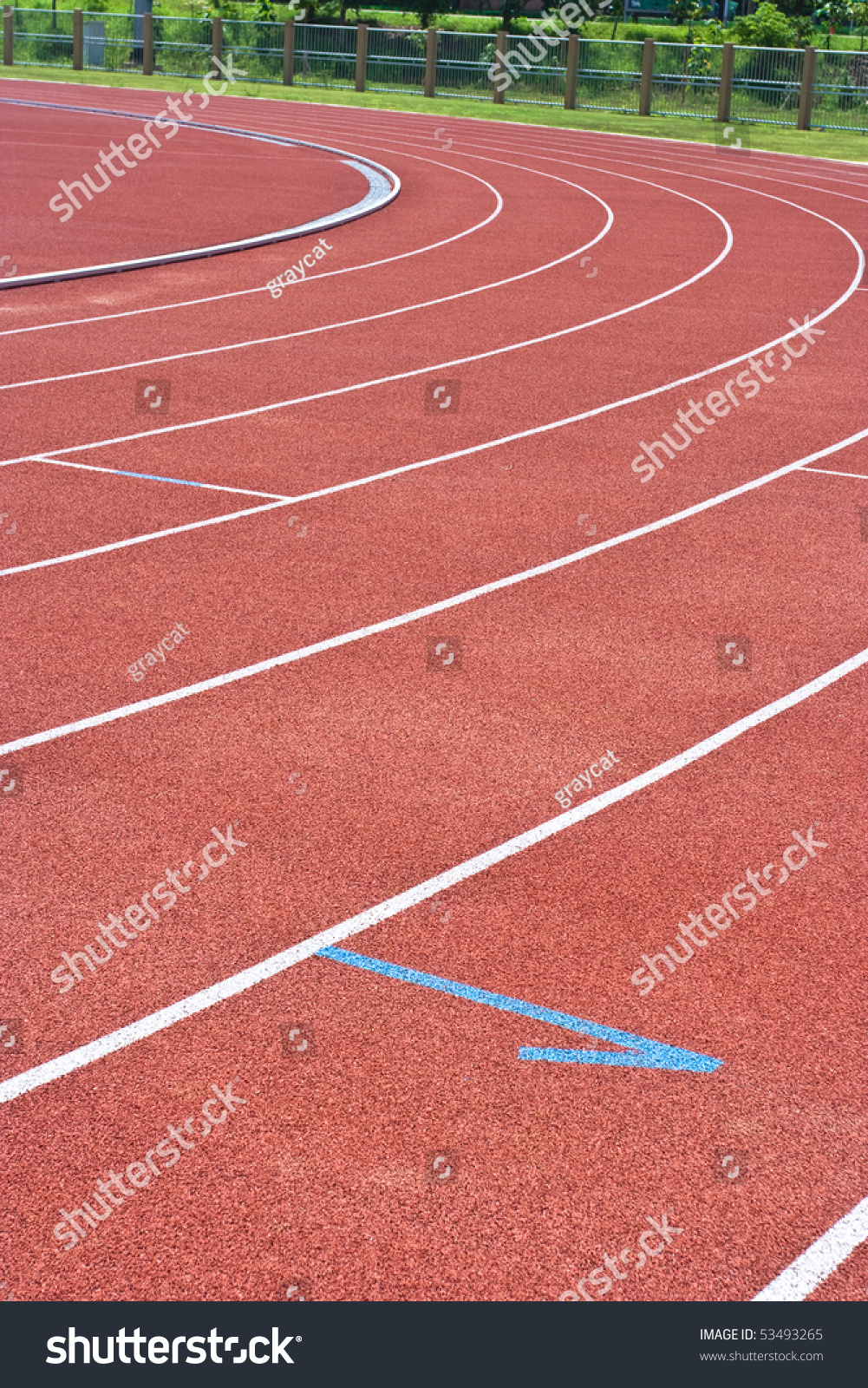 A university running track, around an football field. #53493265