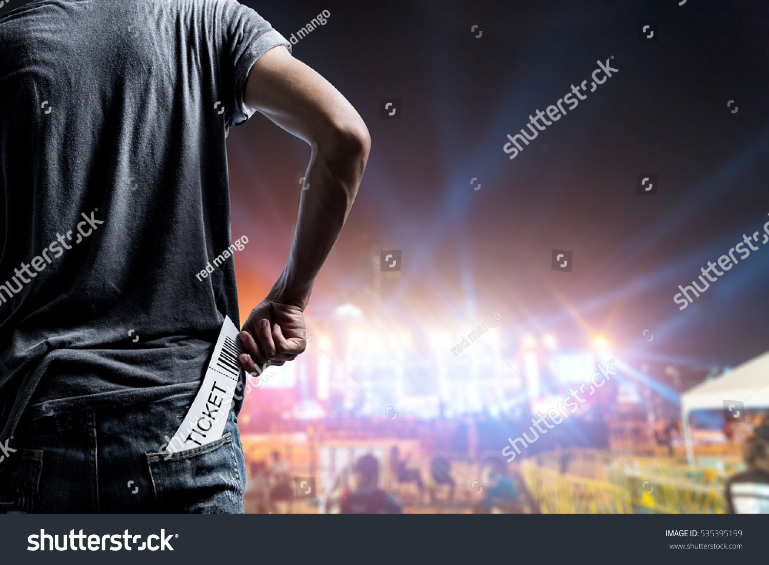 Customer presenting tickets or admission passes watch a rock music concert #535395199