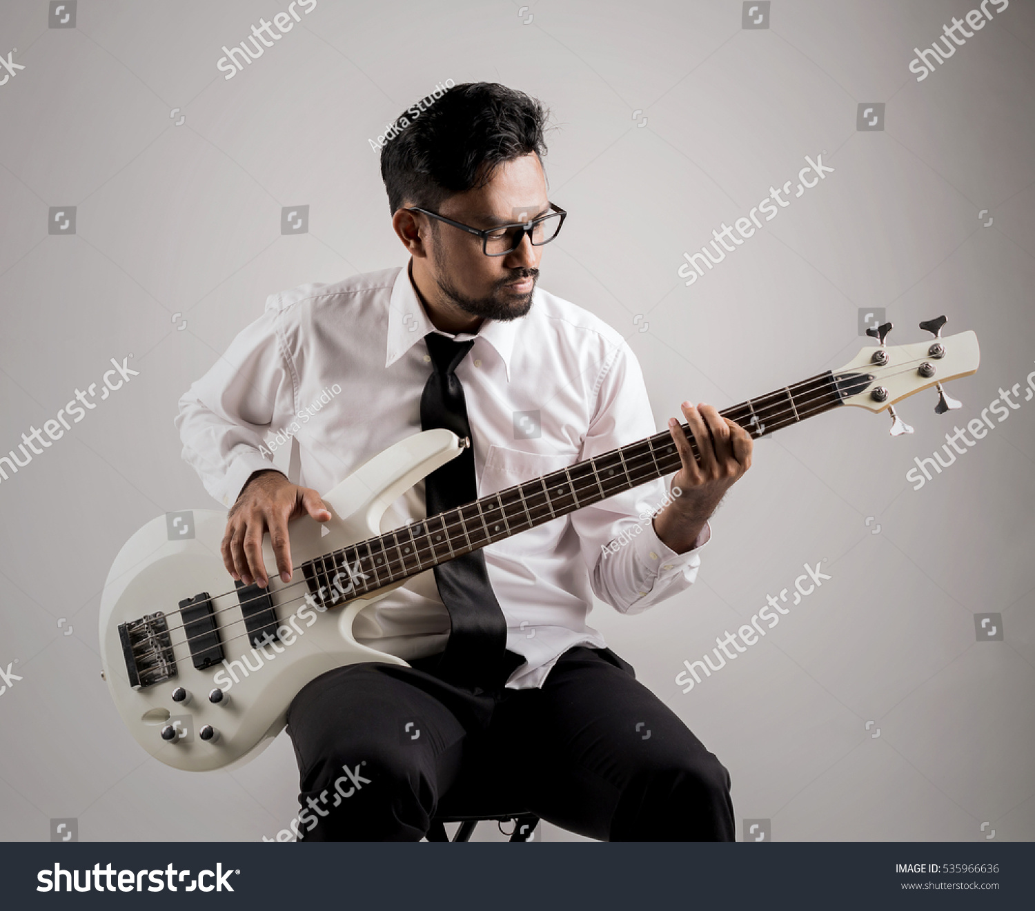portrait of asian businessman playing guitar on the chair #535966636