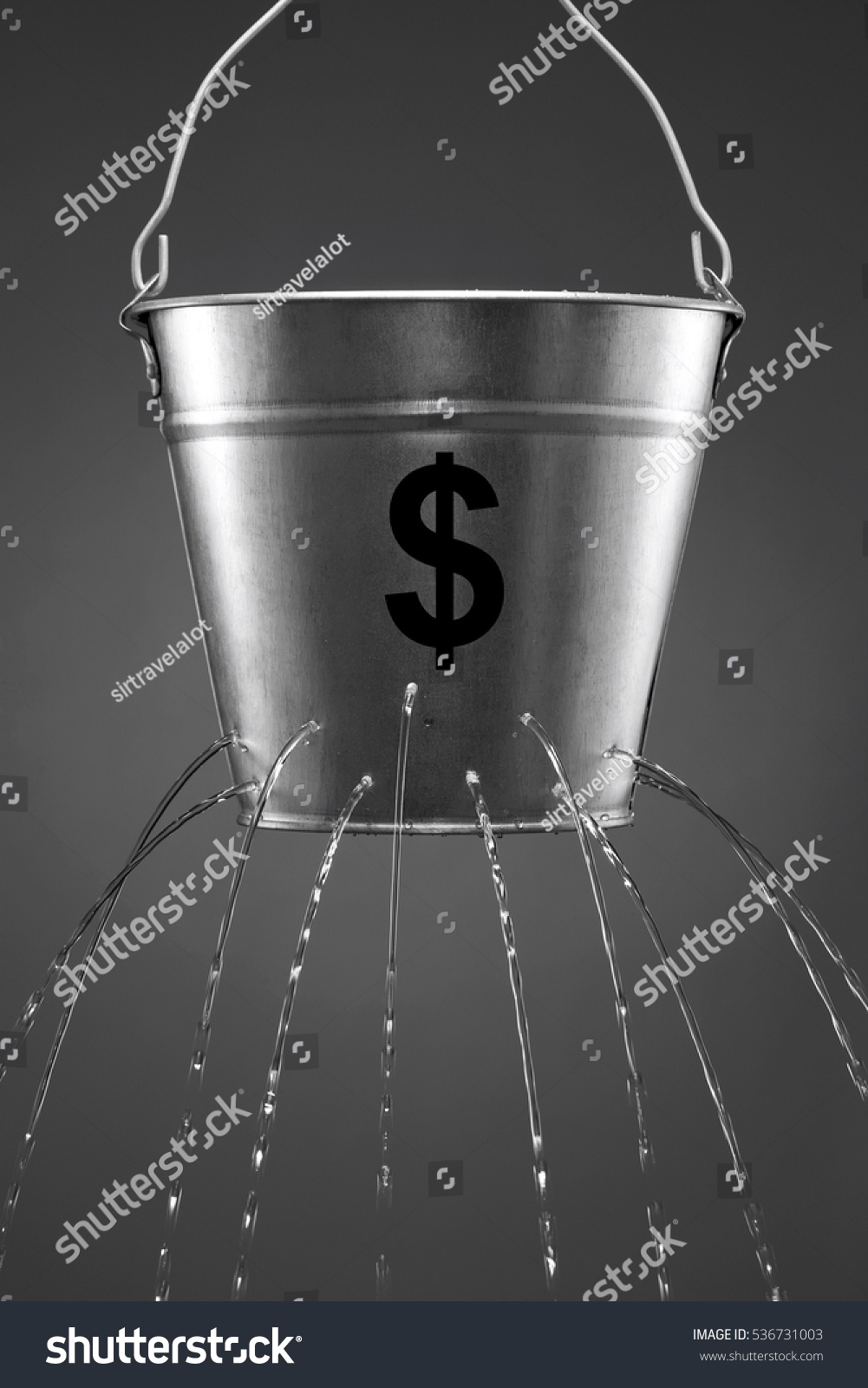 Water leaking from bucket with the concept of finance and losing money #536731003