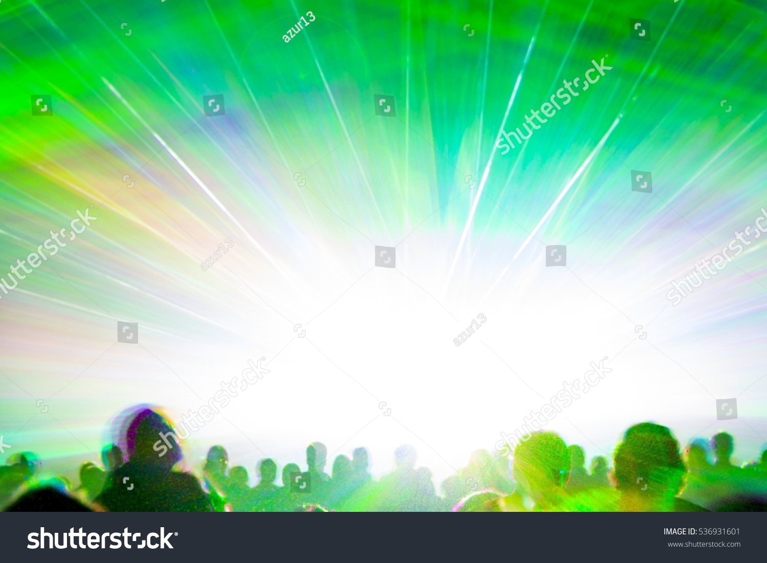 Bright laser show rays stream. Very colorful show with a crowd silhouette and great laser rays on pyrotechnic festival in germany #536931601