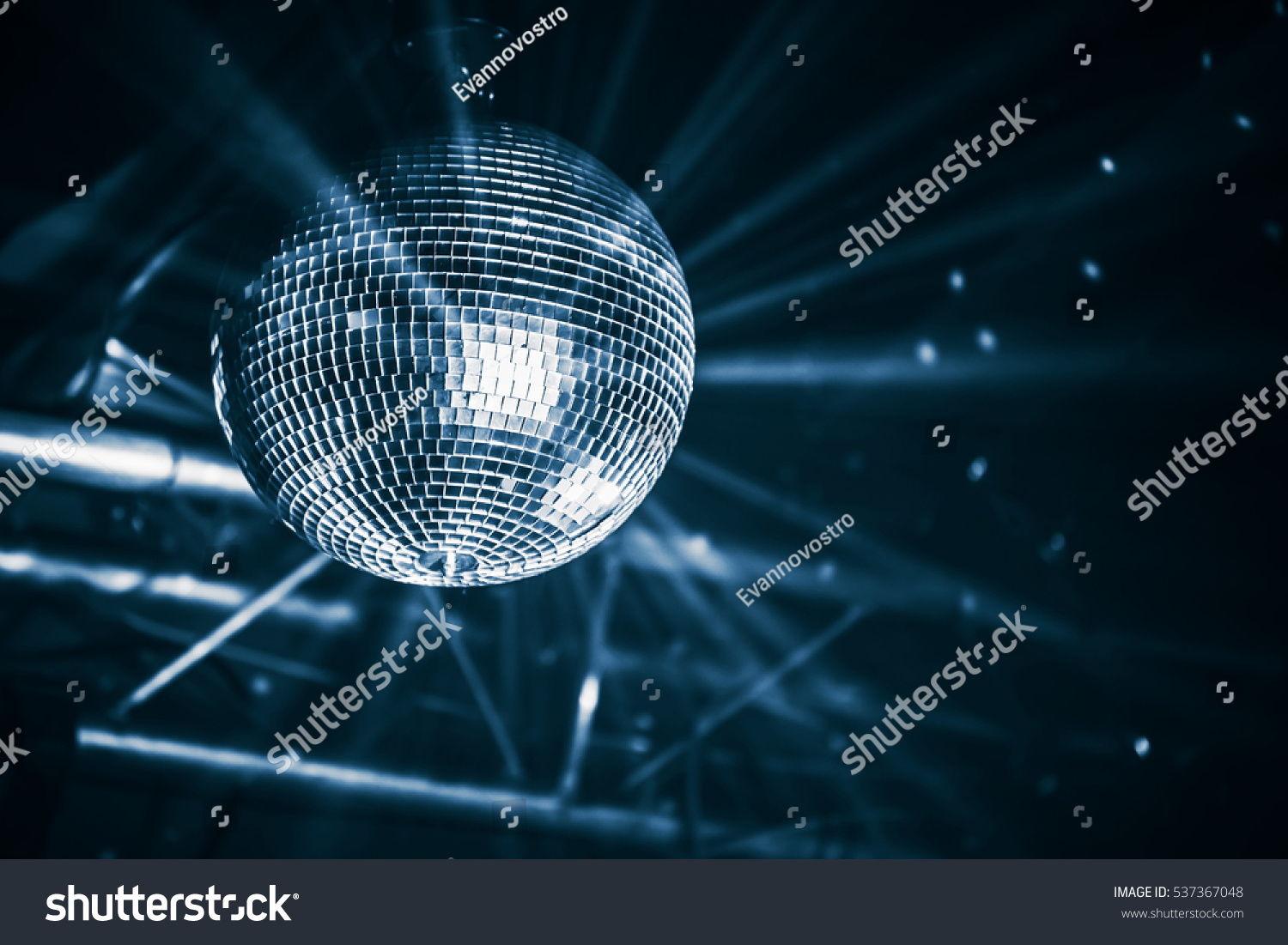 Disco ball with bright rays, blue toned night party background photo #537367048