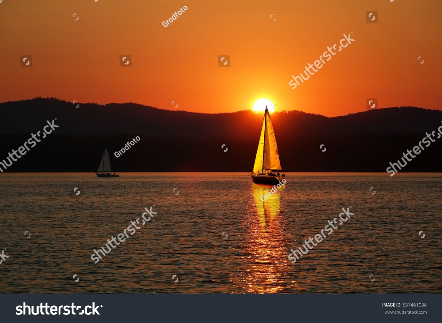Sailboats on the beautiful Lake of the Southern Urals.Sailboat in the sunset.Summer travel.                               #537461038