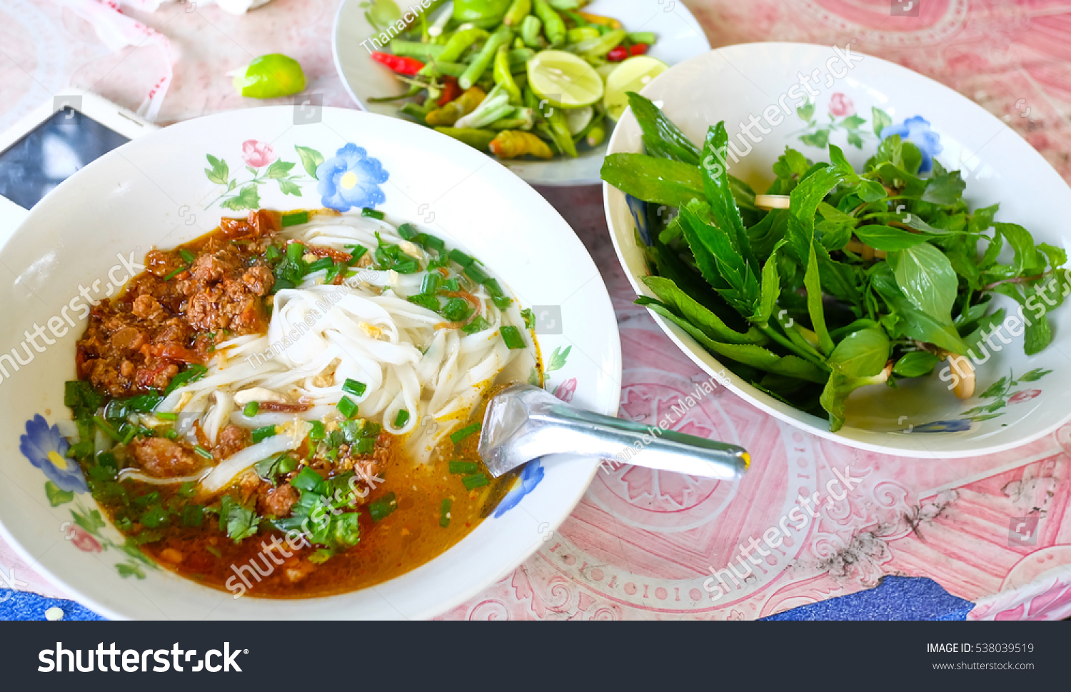 laos food ,Pho, Laos Style Beef Noodle Soup with vegetables on table. #538039519