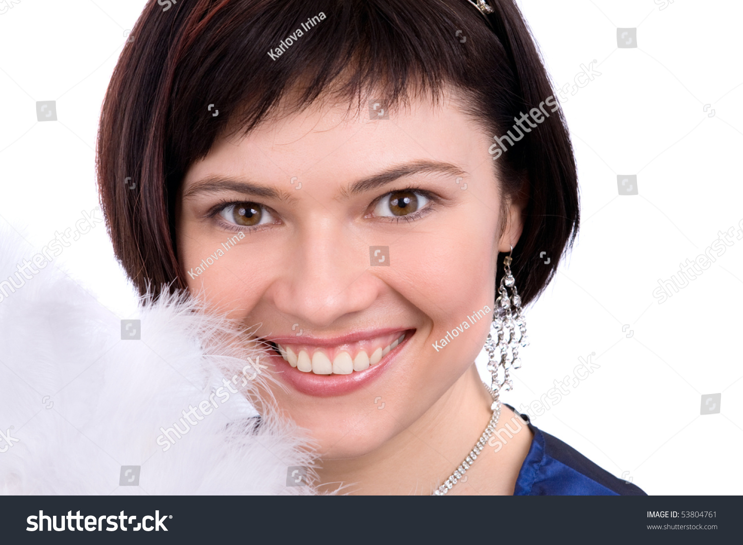 Close-up of beautiful woman with white feather. The angel has perfect eyes and white feathers. Beautiful model with snowy wintry look on white background. #53804761