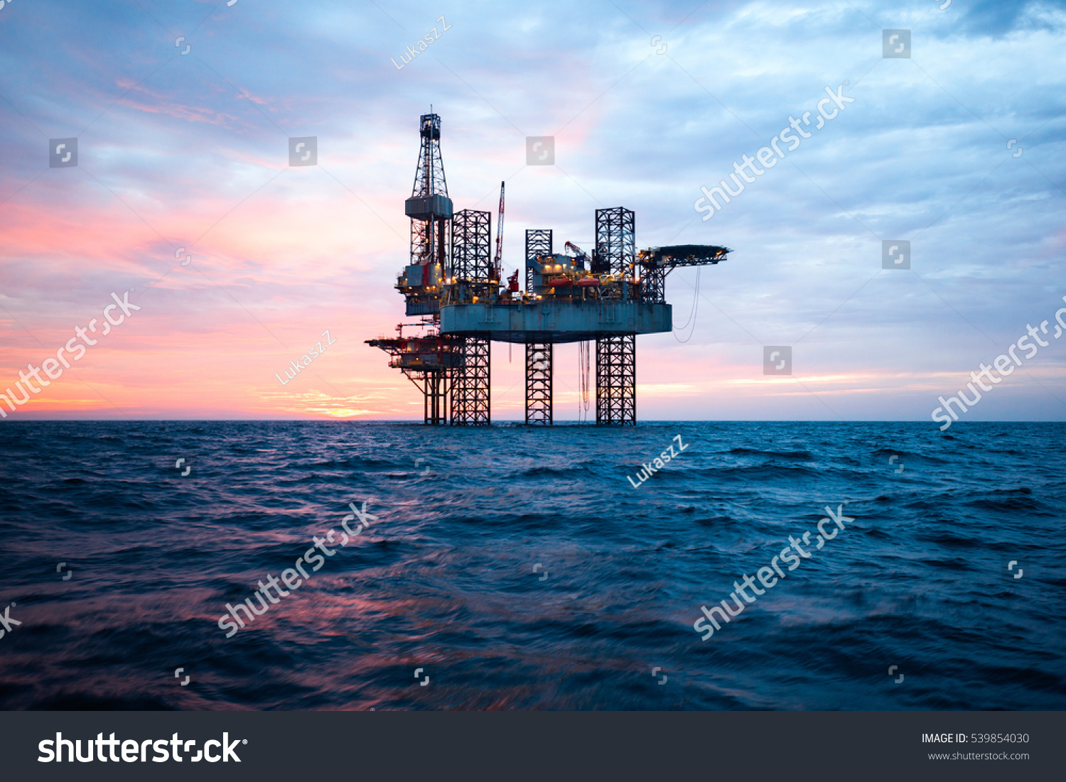 Offshore Jack Up Rig in The Middle of The Sea at Sunset Time #539854030