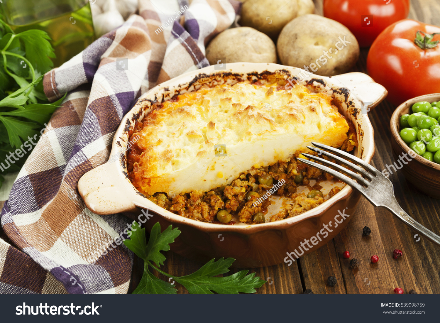 Cottage pie with meat and green peas #539998759