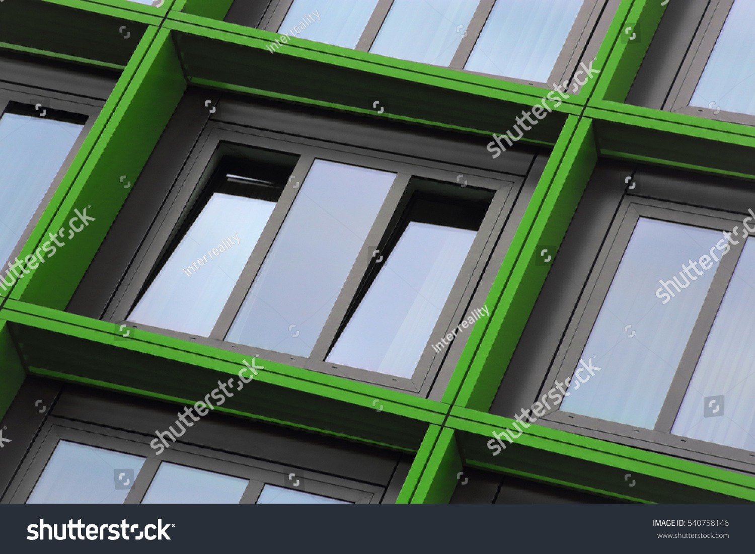 Tilt close-up photo of ajar windows in green frames. Eco-friendly technologies / energy saving motif. Building exterior detail. Abstract photo on the subject of modern architecture. #540758146