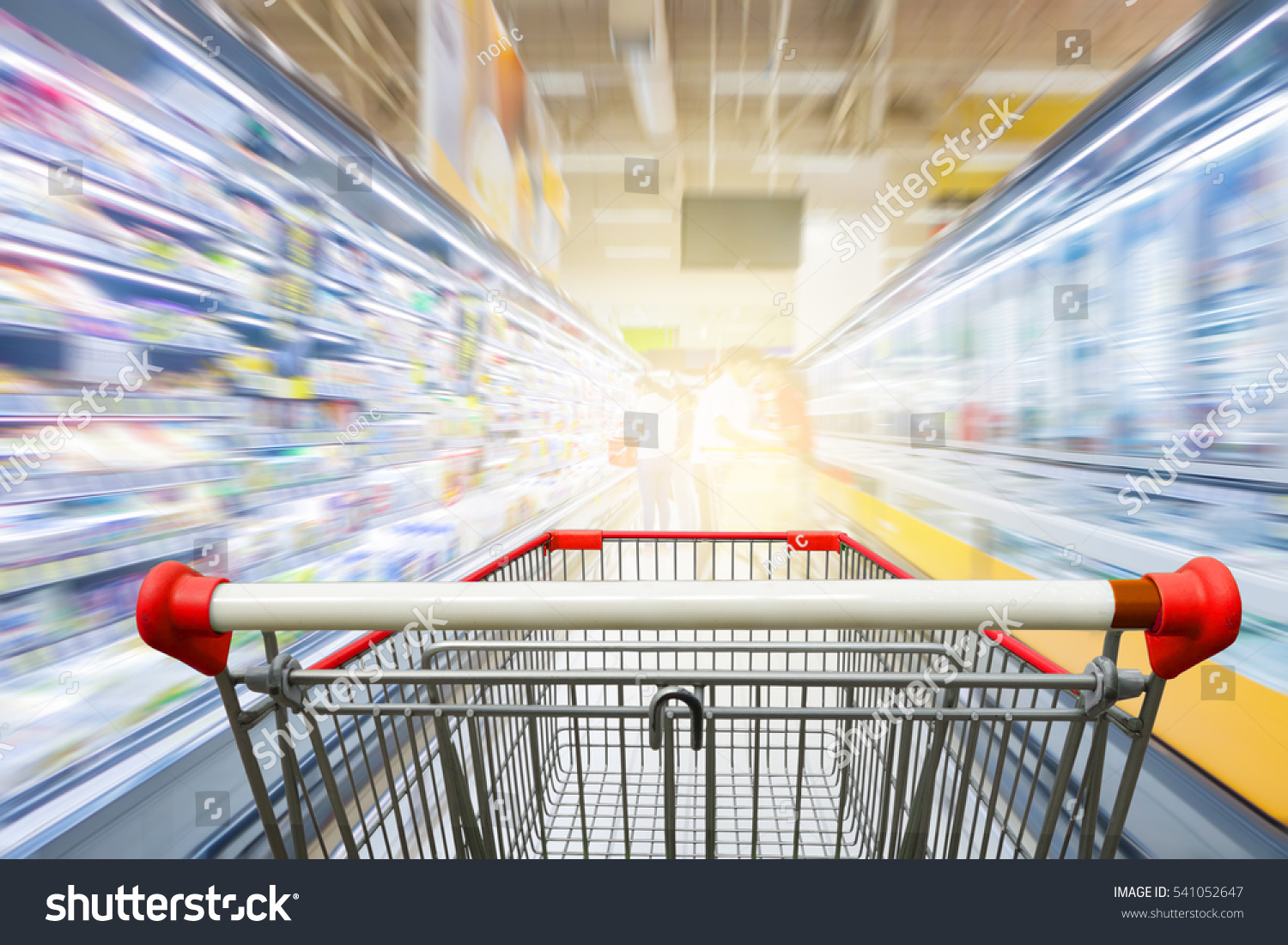 Supermarket aisle with empty red shopping cart #541052647