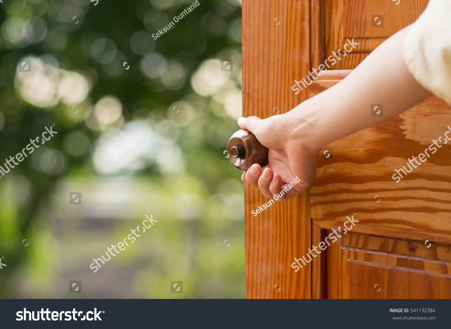 Women hand open door knob or opening the door. #541132384