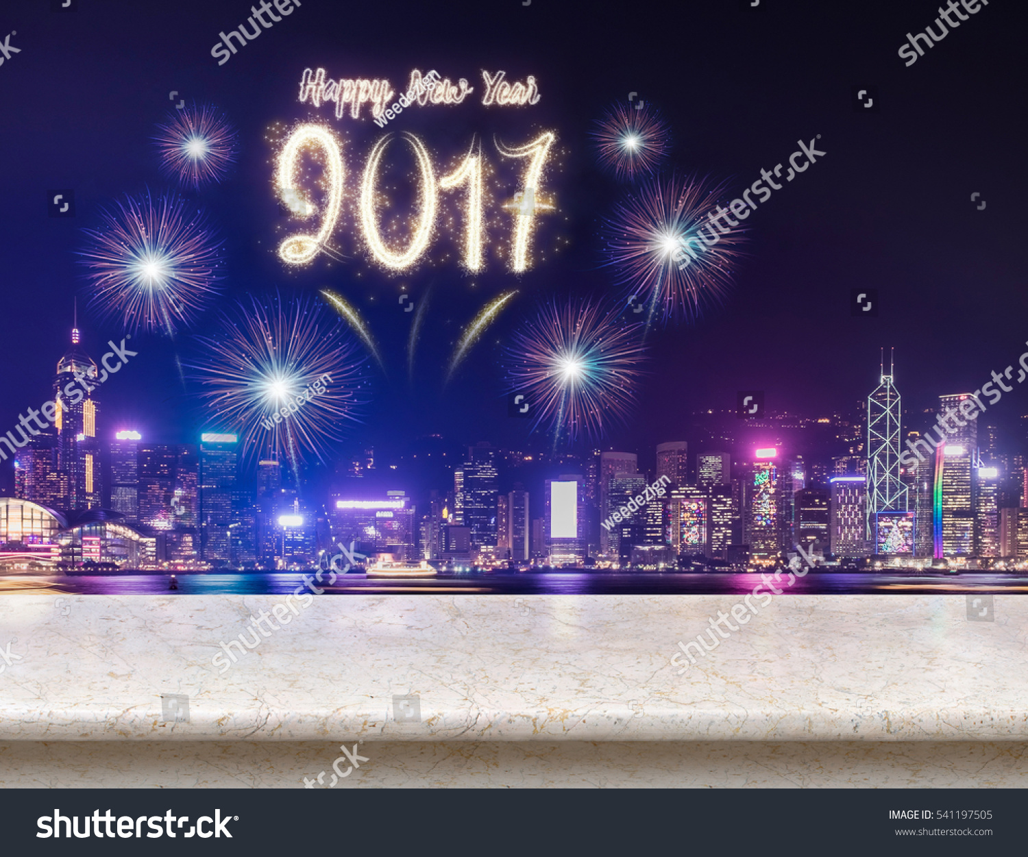 Happy new year 2017 fireworks over cityscape at night with empty cream marble table,Mock up template for display or montage of product for social media advertising #541197505