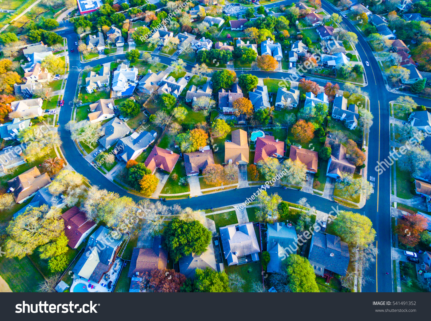 Aerial View Over Modern Suburb Home Community neighborhood with colorful Fall Autumn trees around curved streets and new development outside of Austin , Texas  #541491352