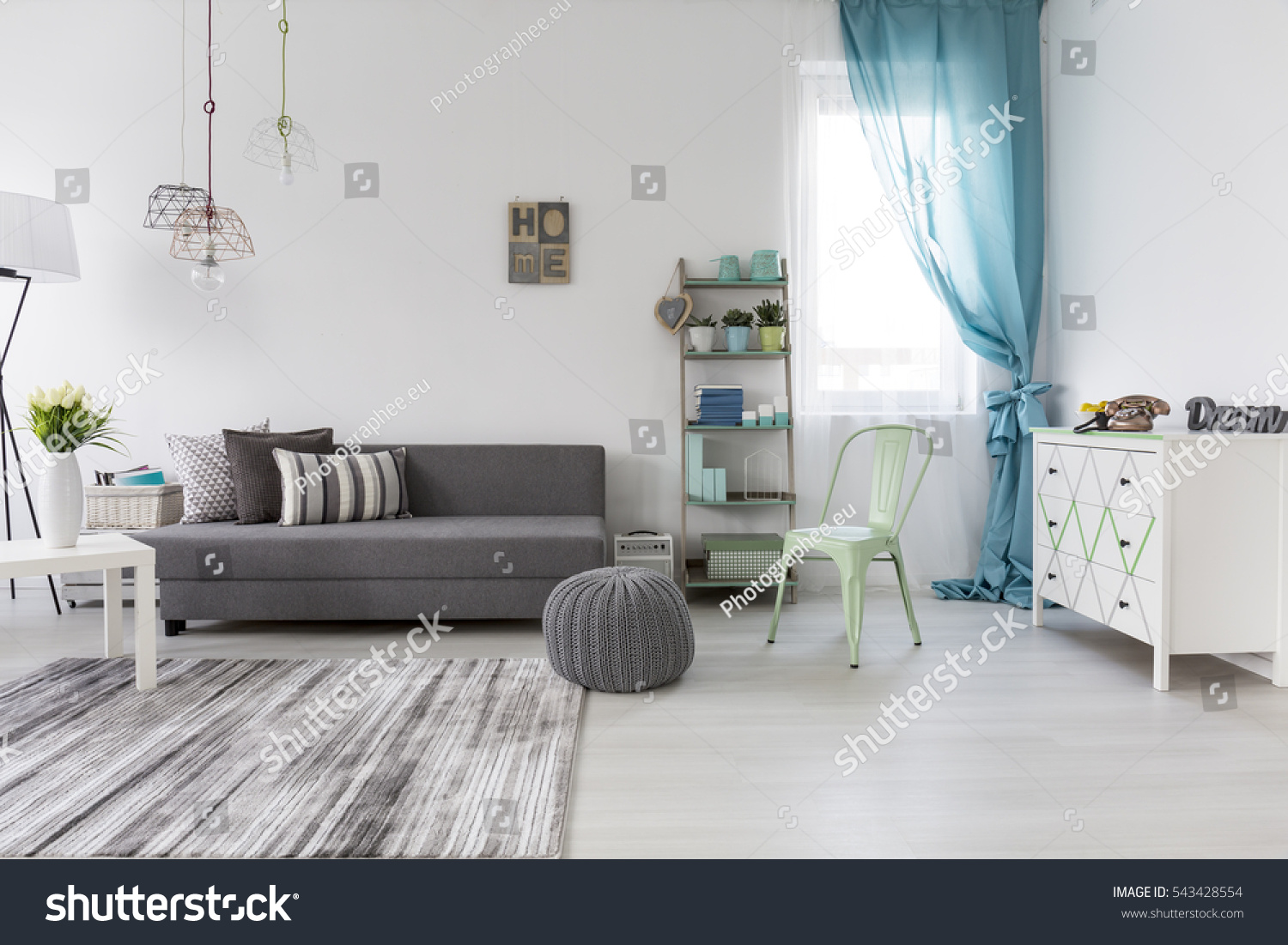 Bright spacious living room with comfortable couch and chest of drawers #543428554