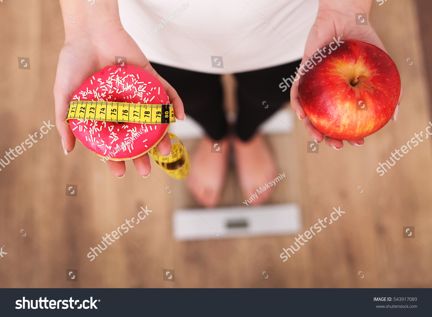 Diet. Woman Measuring Body Weight On Weighing Scale Holding Donut and apple. Sweets Are Unhealthy Junk Food. Dieting, Healthy Eating, Lifestyle. Weight Loss. Obesity. Top View #543917089