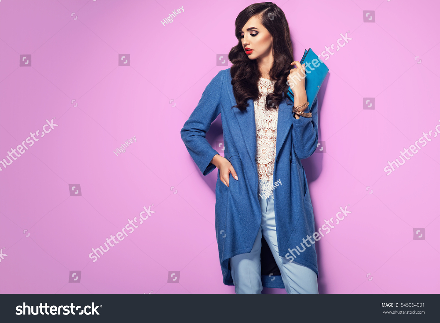 Beautiful brunette woman in a blue coat and nice top. Fashion spring autumn winter photo #545064001