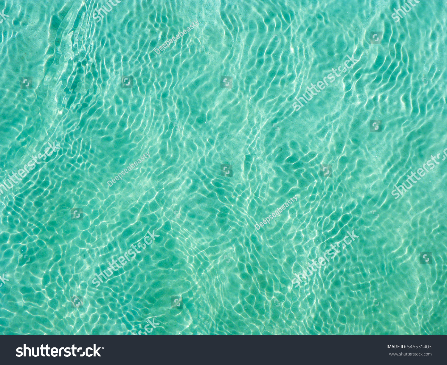 Turquoise Water near to the Sand underneath forming many little waves reflecting the Sun, Thailand #546531403