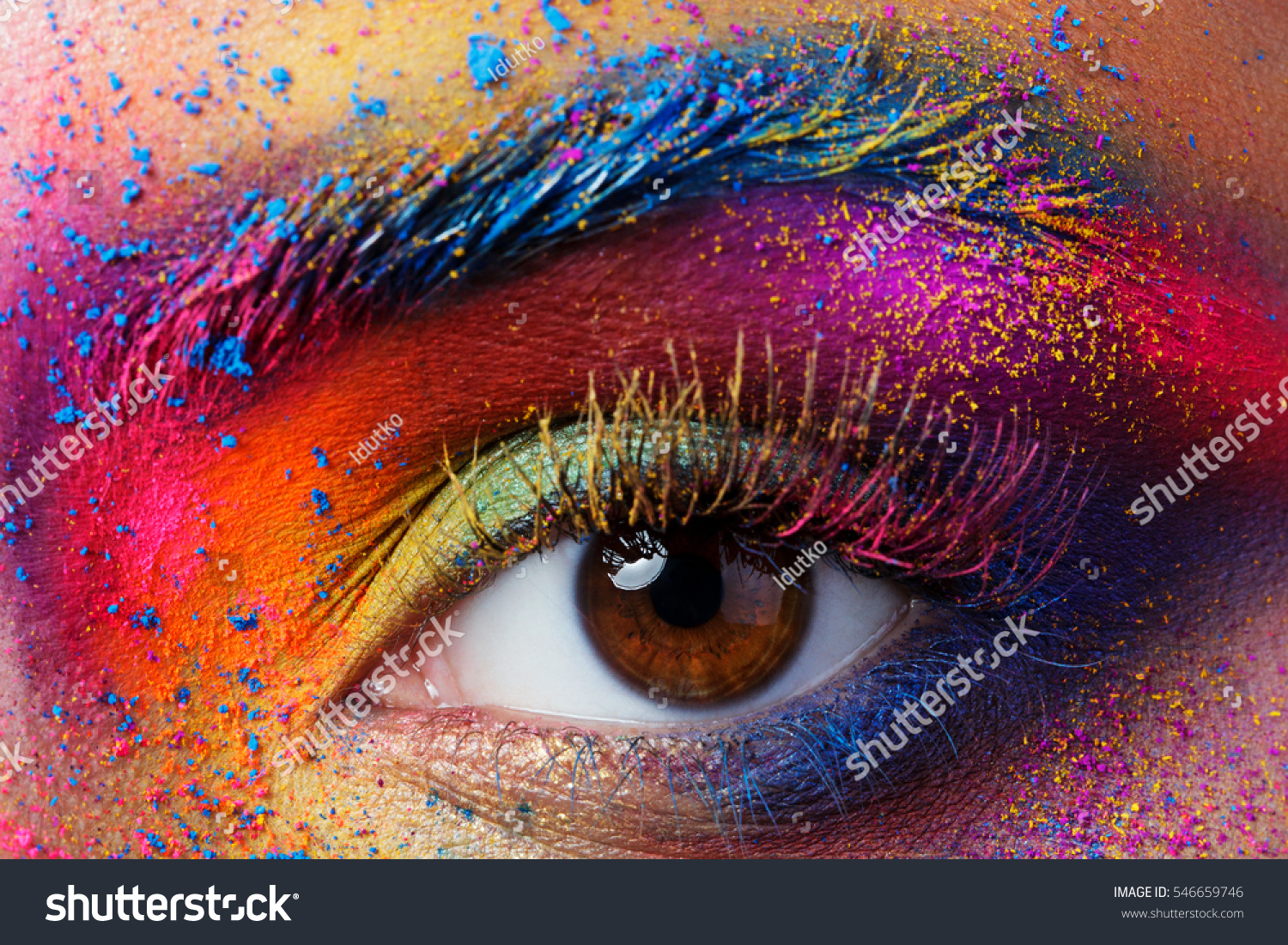 Close up view of female eye with bright multicolored fashion makeup. Holi indian color festival inspired. Studio macro shot #546659746