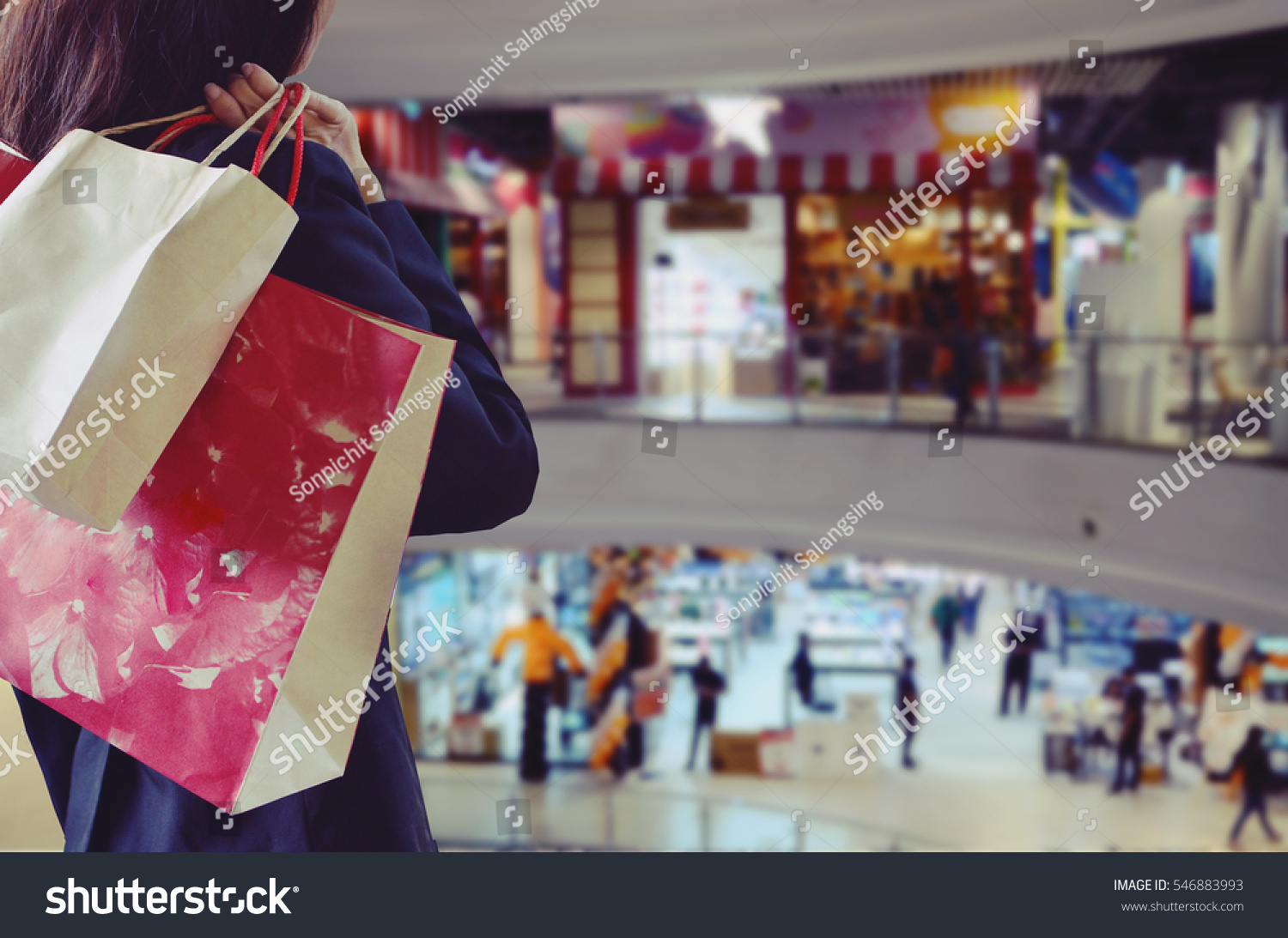 Woman holding shopping bags in the shopping mall
 #546883993