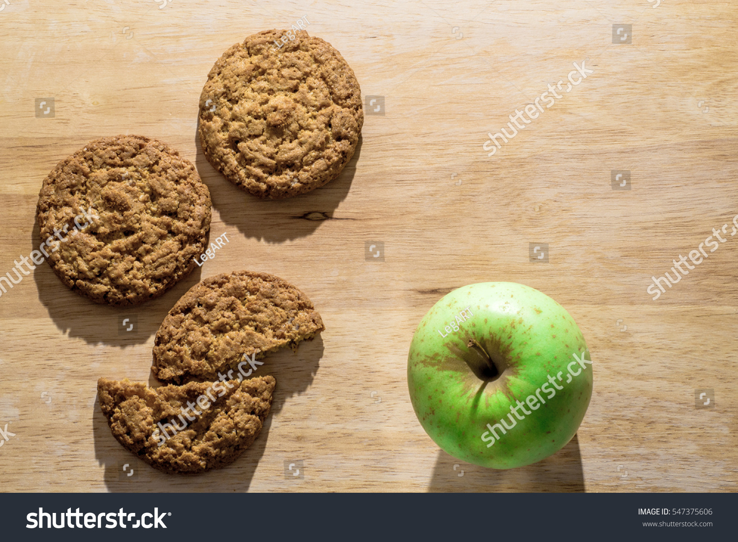 Oatmeal cookies on a wooden board with green apple. Flat lay #547375606