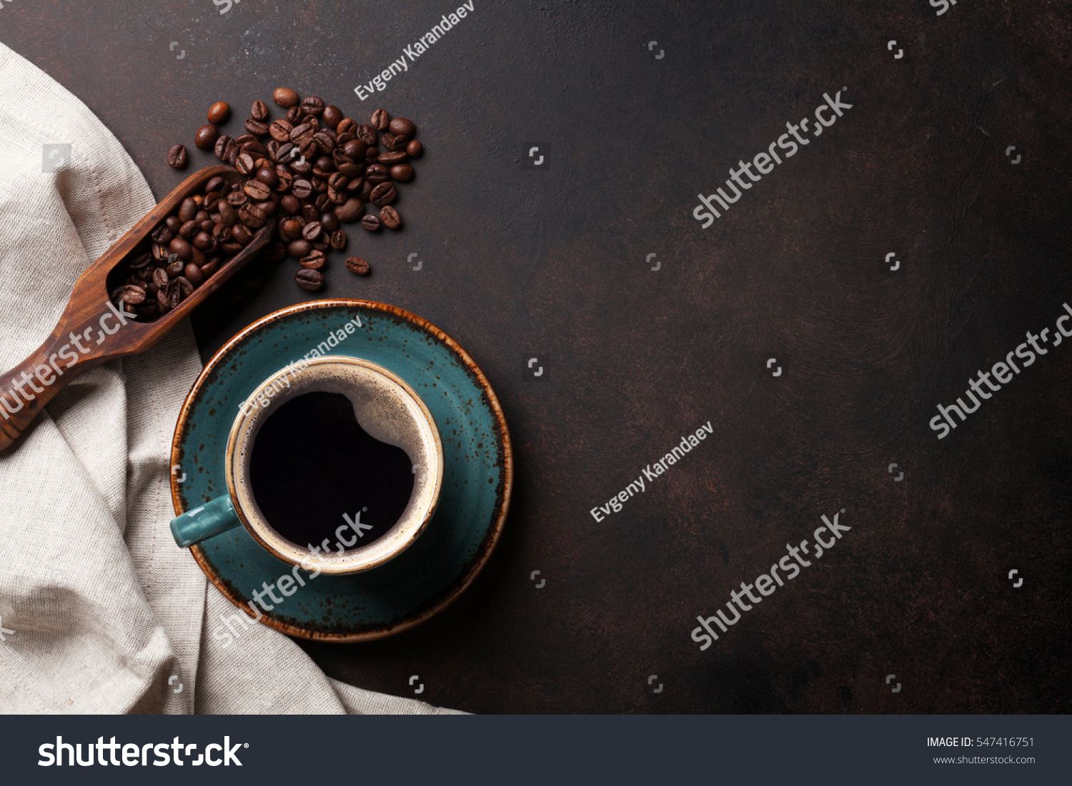 Coffee cup and beans on old kitchen table. Top view with copyspace for your text #547416751