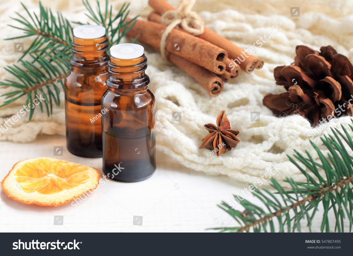 Essential oil blend. Dark glass bottles, cinnamon, pine twigs, dried citrus slice, anise, woolen wrap. Natural home deodorants. Warm toned.  #547807495