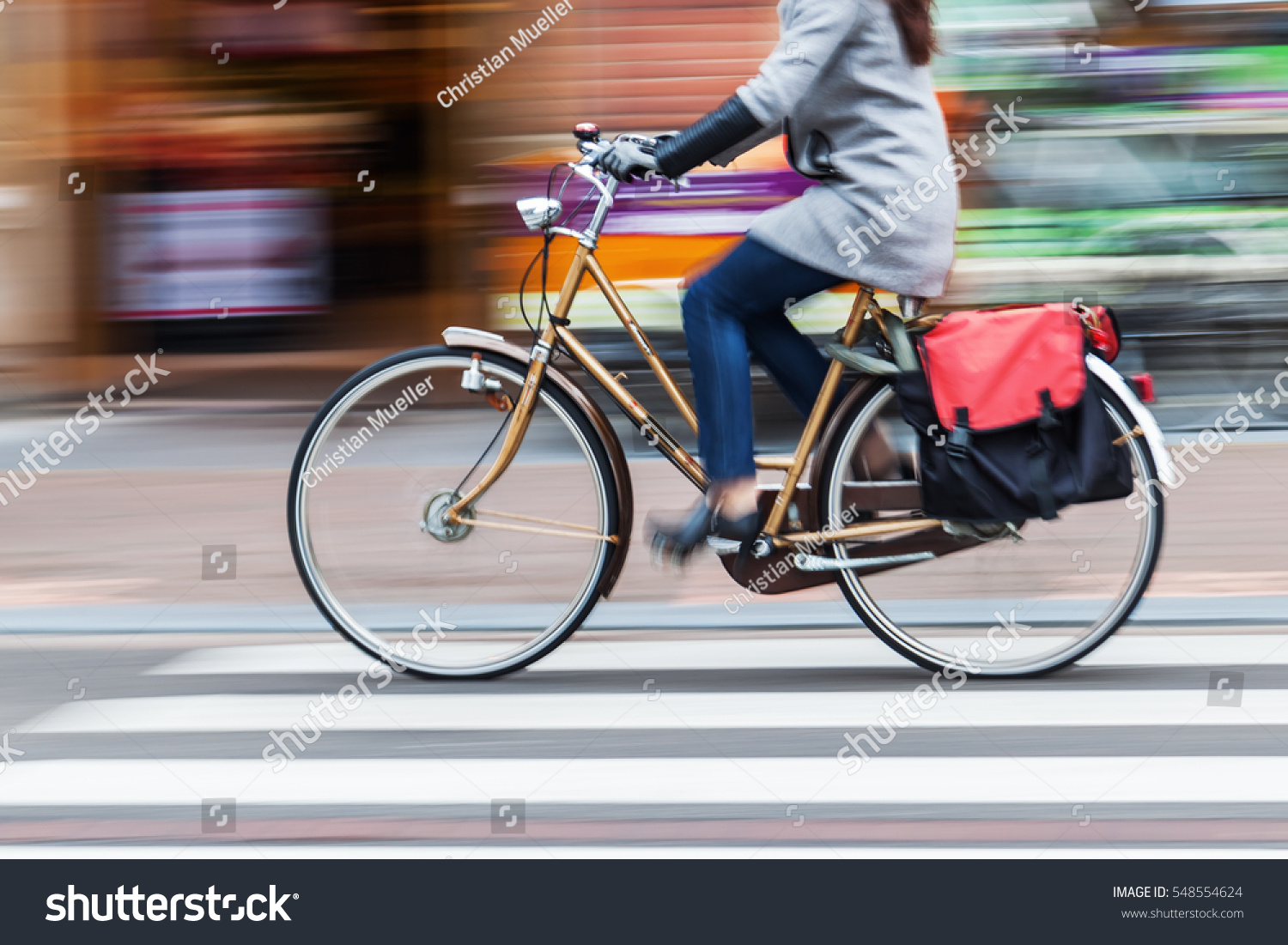 bicycle rider in the city in motion blur #548554624