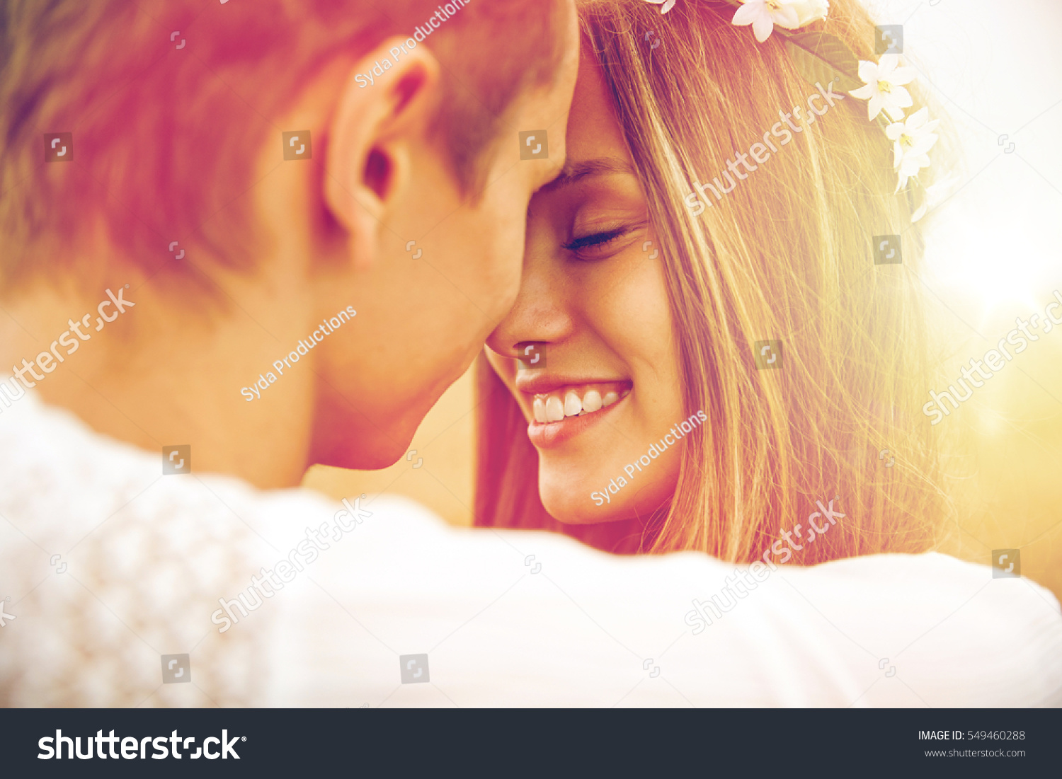 summer holidays, love, romance and people concept - happy smiling young hippie couple hugging outdoors #549460288