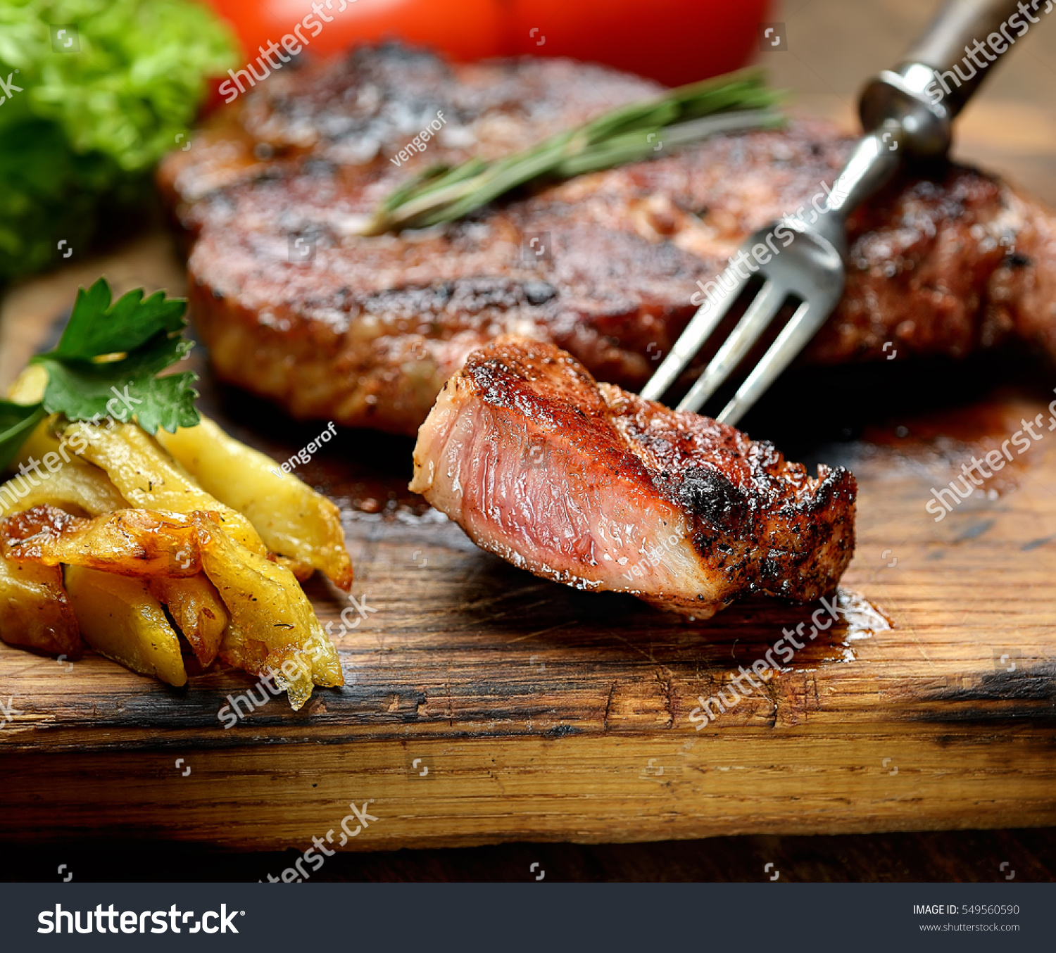 grilled juicy steak with rosemary.  #549560590