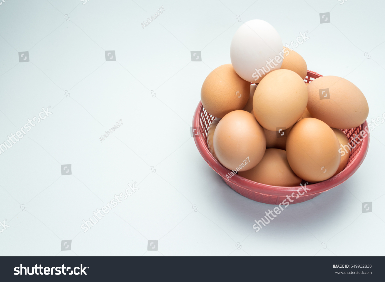 egg in basket on white background and single white egg #549932830