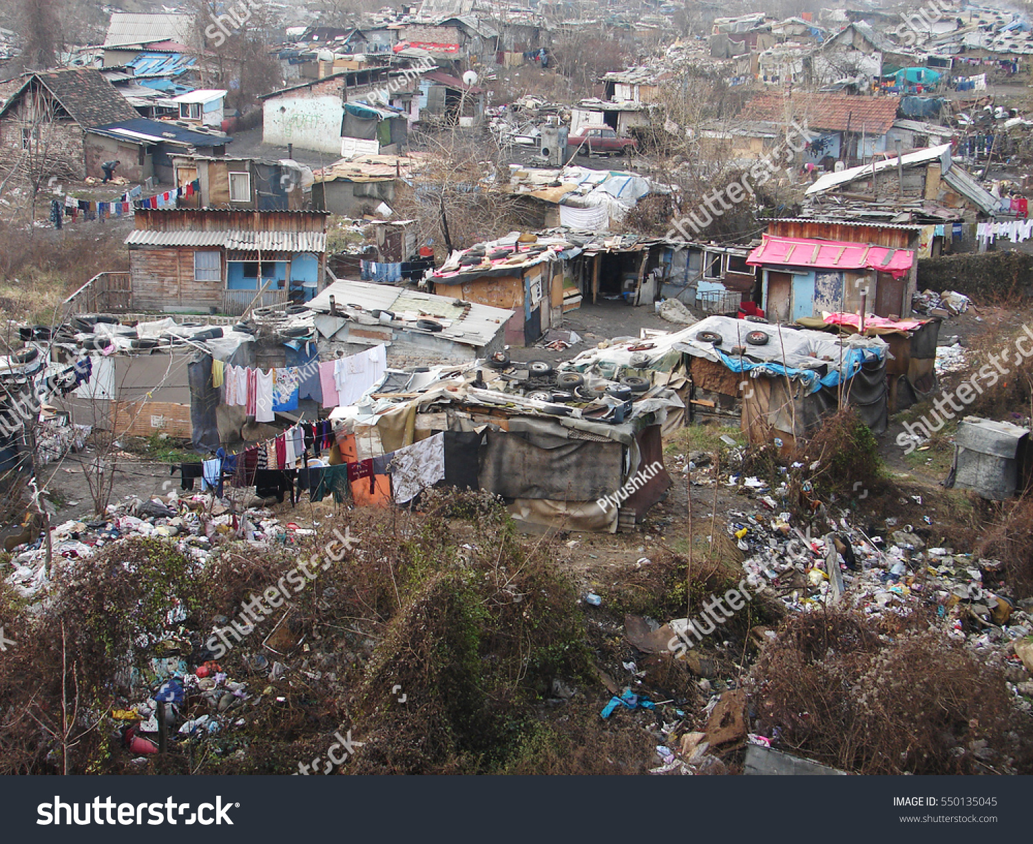 Gypsy slum favela in Belgrade, Serbia, town city urban settlement, poverty, garbage junkyard, houses and shacks made of wood or metal, Coronavirus COVID-19 pandemic epidemic crisis outbreak, hygiene #550135045