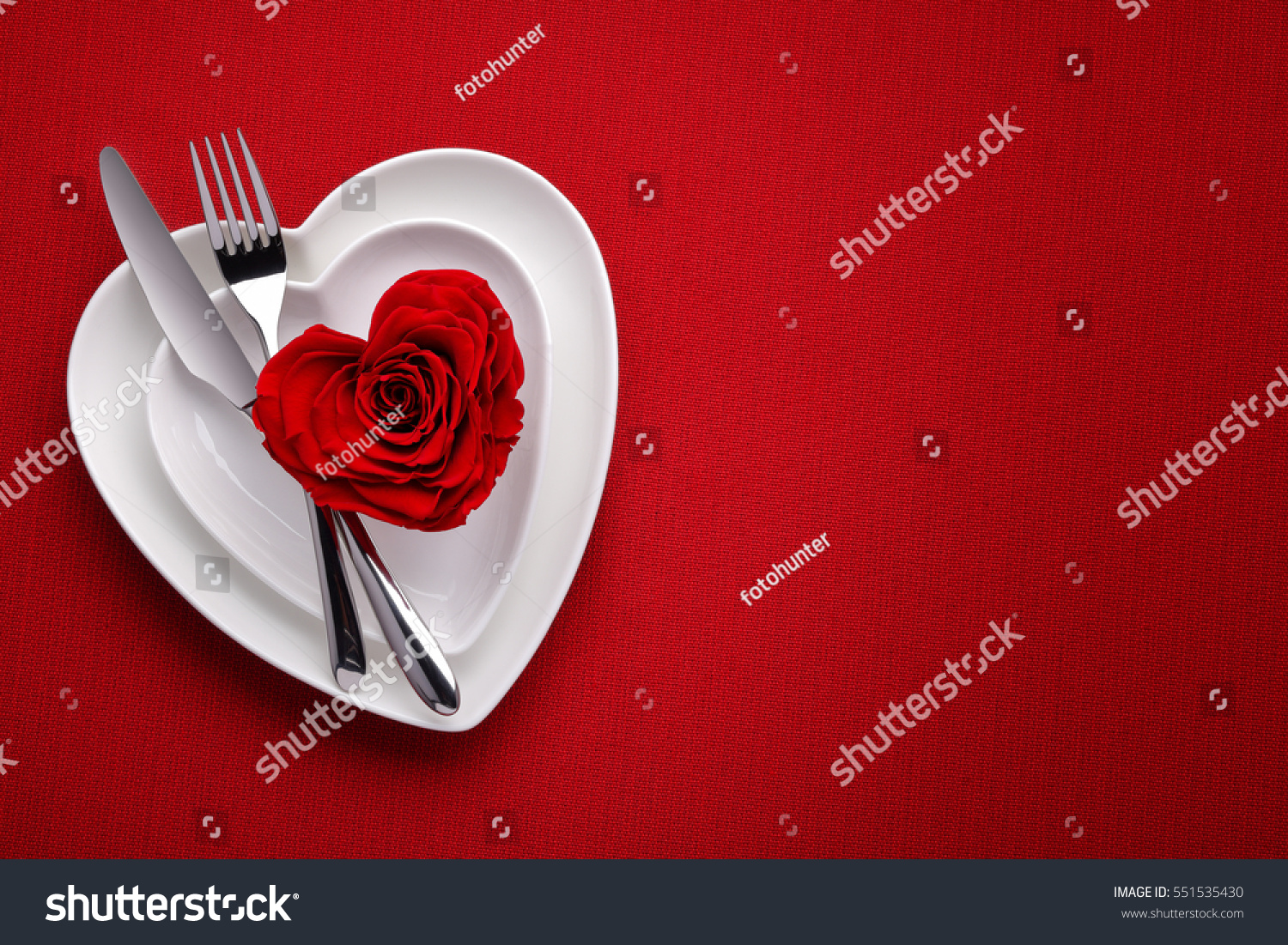 Red rose on white dish.Meal on Valentines Day #551535430