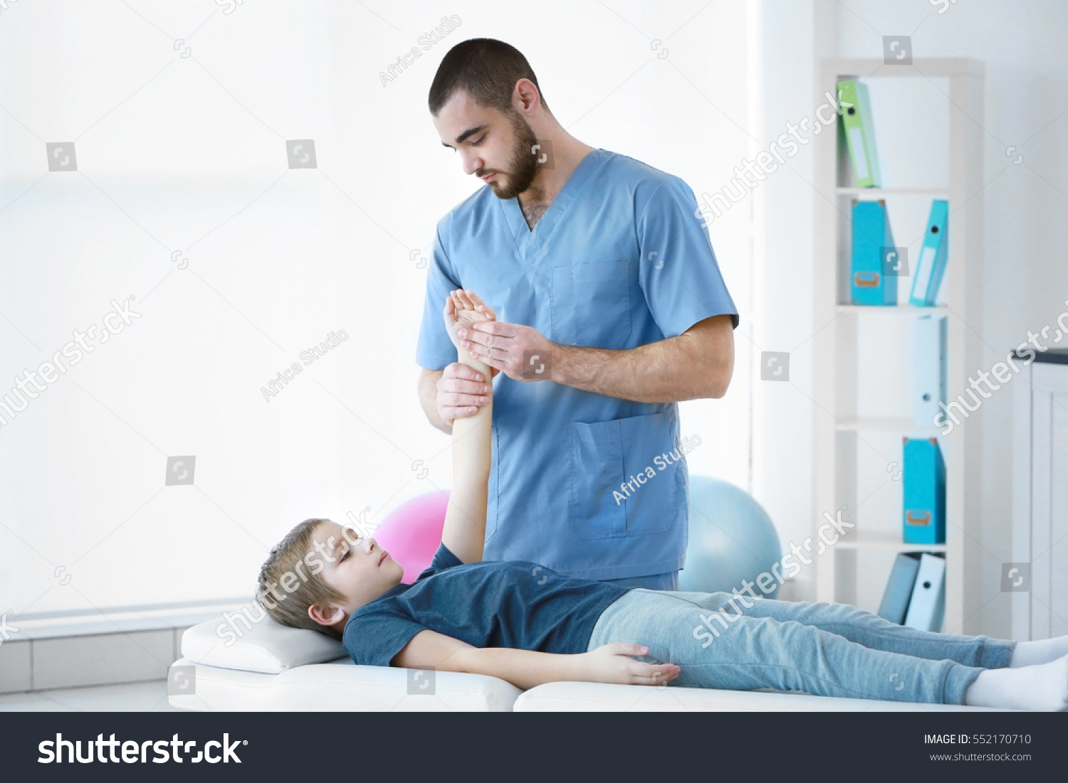 Physiotherapist working with patient in clinic #552170710