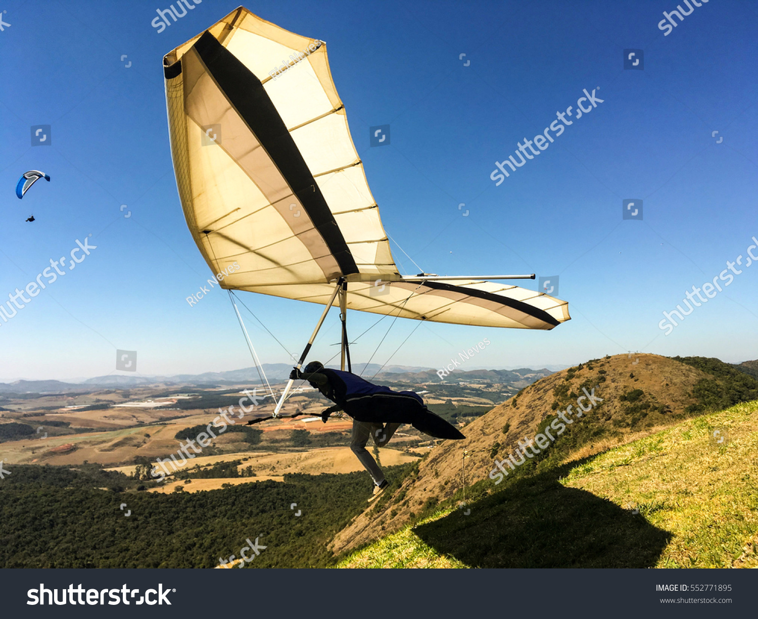 hang gliding launching at beautiful sunny day. Adventure concept #552771895