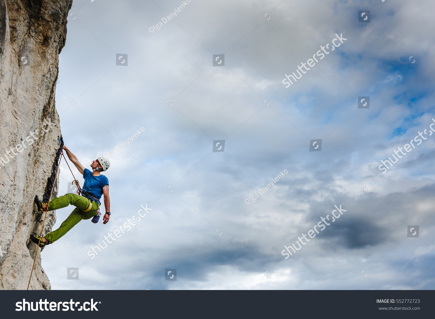 Young male climber hanging by a cliff #552772723