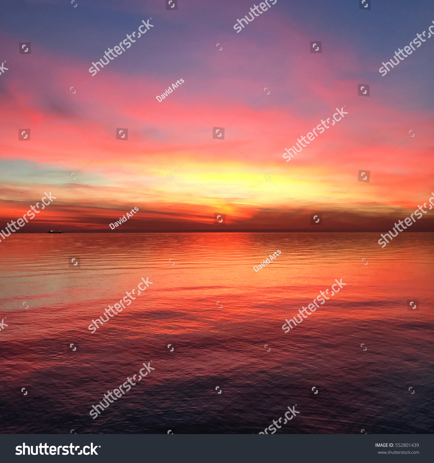 Incredibly Colorful sunset at Trieste Italy. Raibow color at a rock beach. #552801439