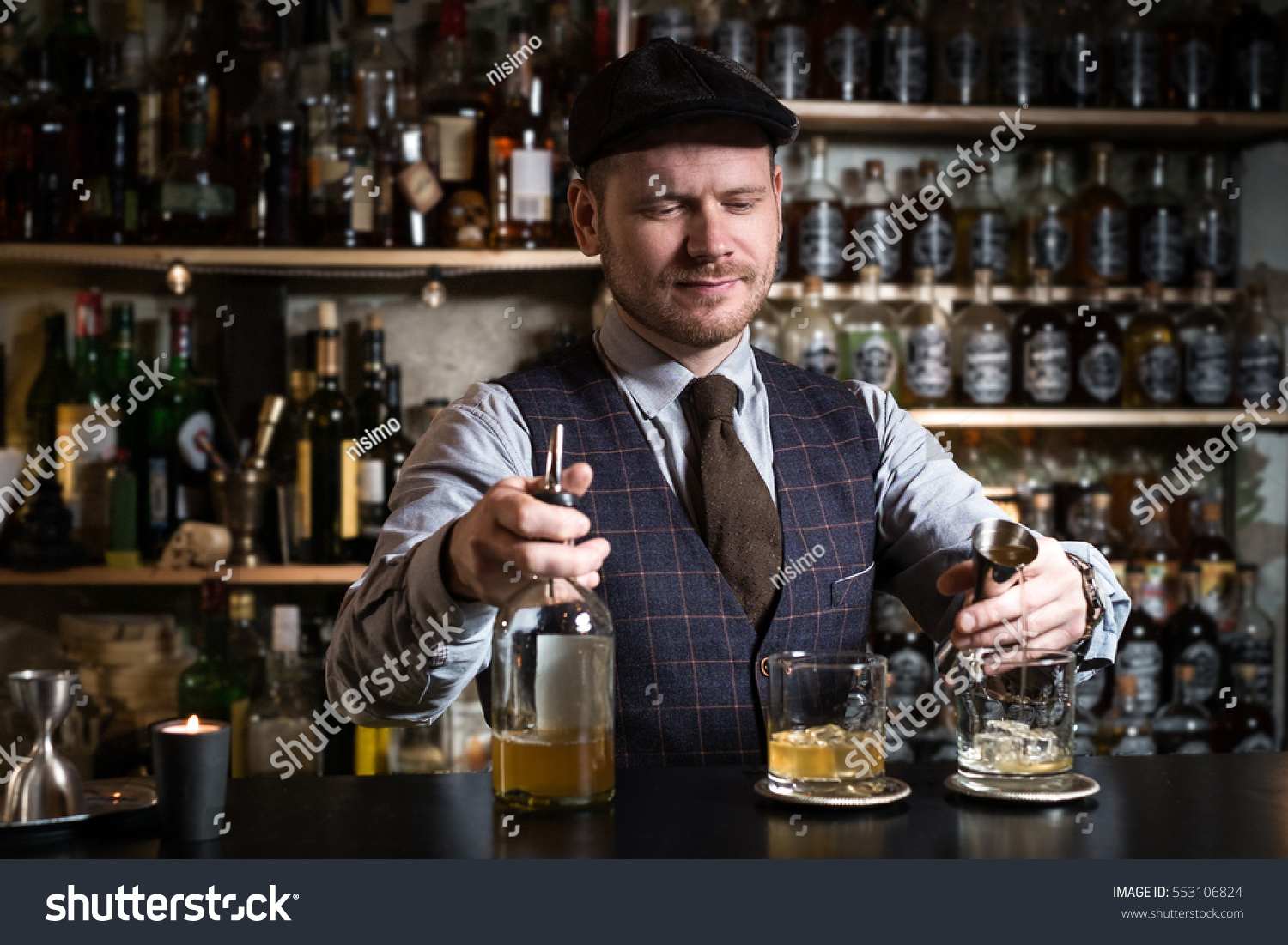 Bartender bartender is pouring a drink #553106824