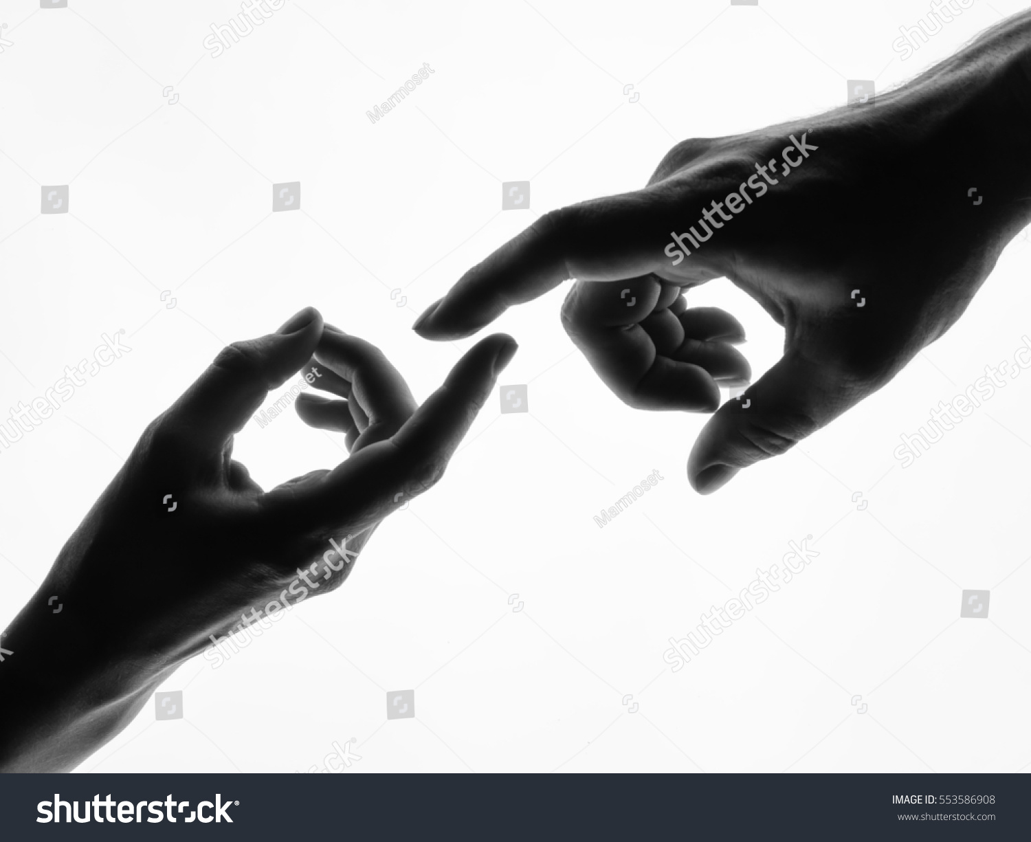 Finger Touching hands silhouette man woman white background couple feeling love. Black and white photo picture #553586908