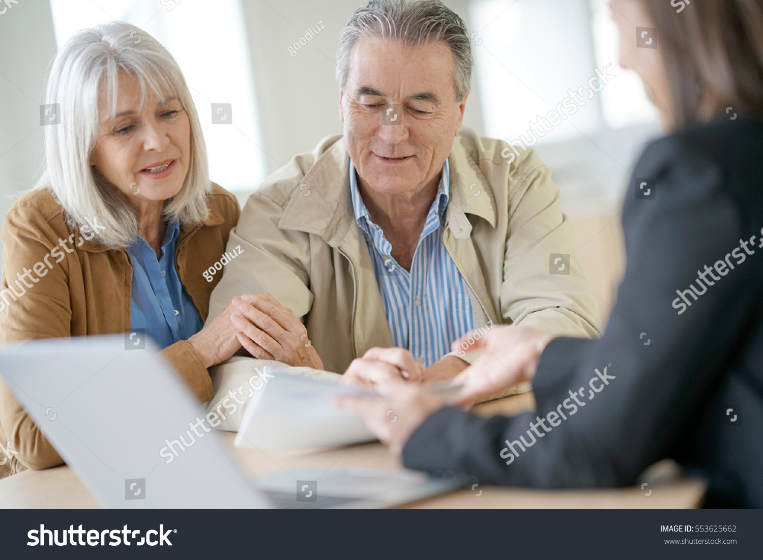 Senior couple meeting financial adviser for investment                 #553625662