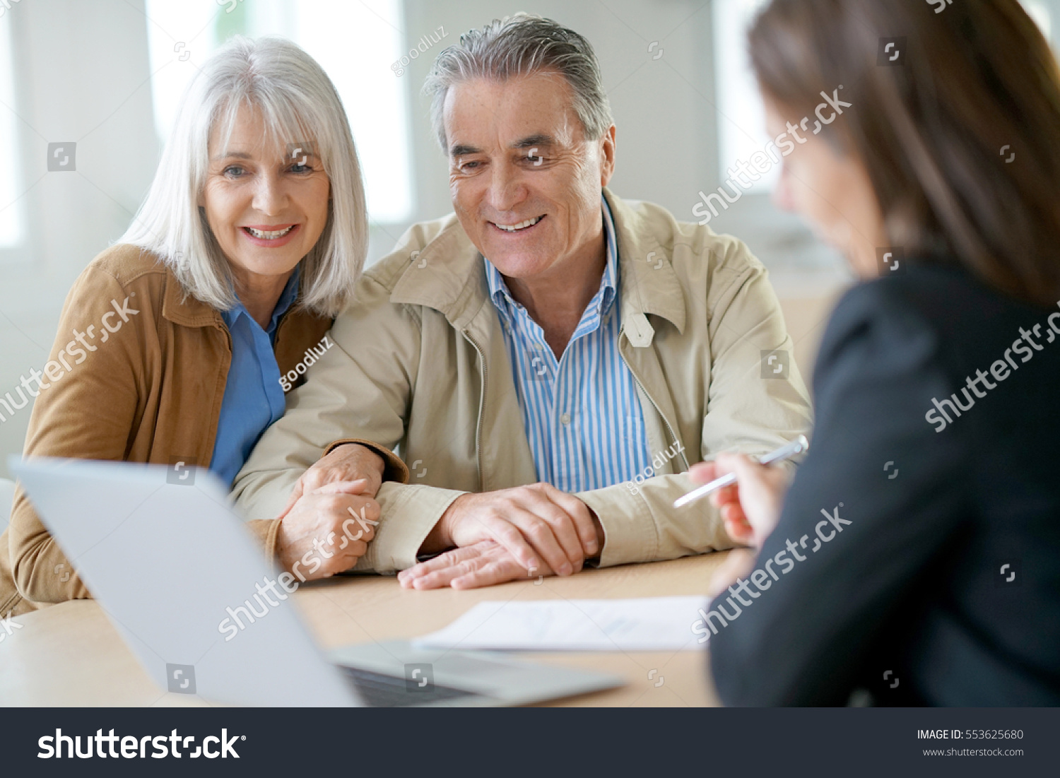 Senior couple meeting financial adviser for investment                 #553625680