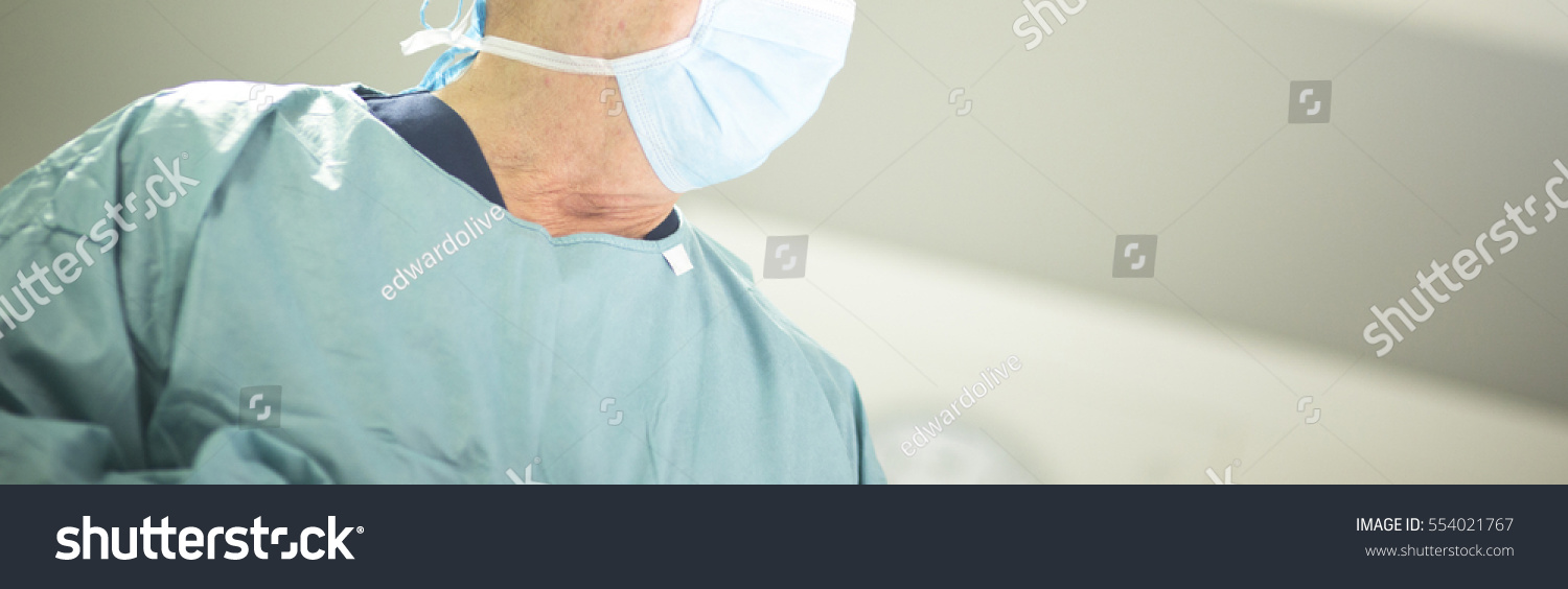 Surgeon in hospital surgery in sterile uniform "scrubs" and mask in operating theater emergency room in surgical operation. #554021767