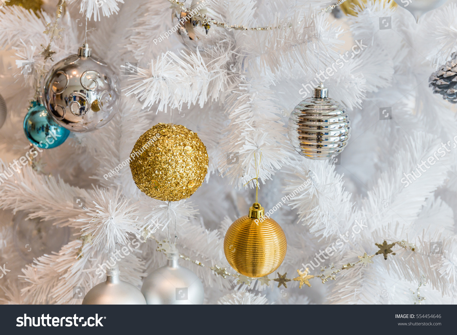 Silver and golden balls garland decoration for christmas and new year festival on white tree #554454646