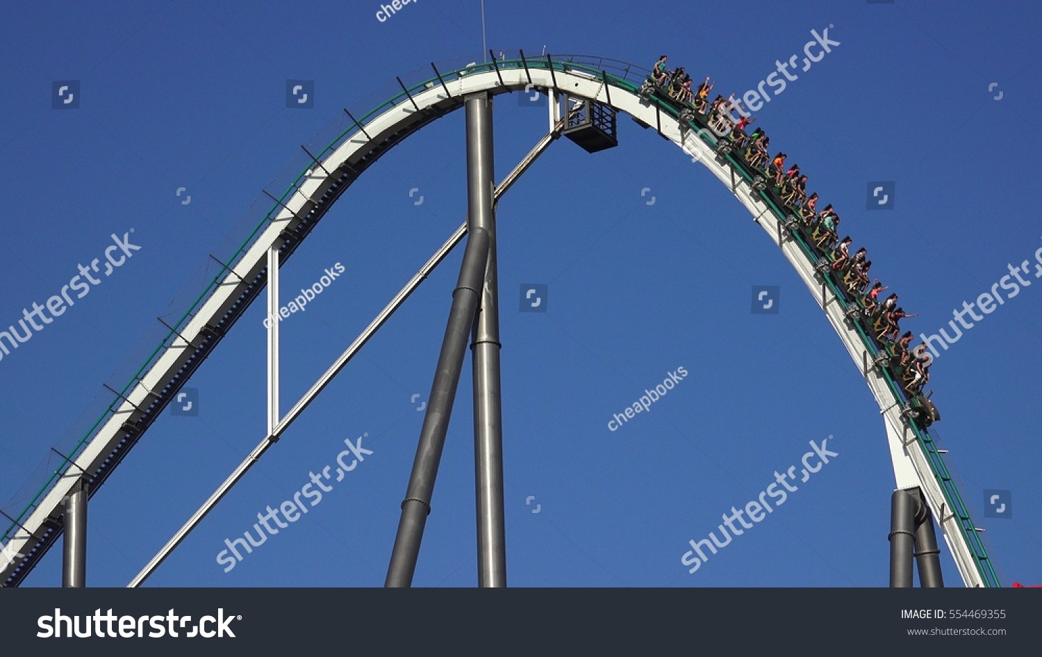 SALOU, SPAIN JULY 5 2016: People On Roller Coaster Thrill Ride on July 5 2016 in Salou, Spain #554469355