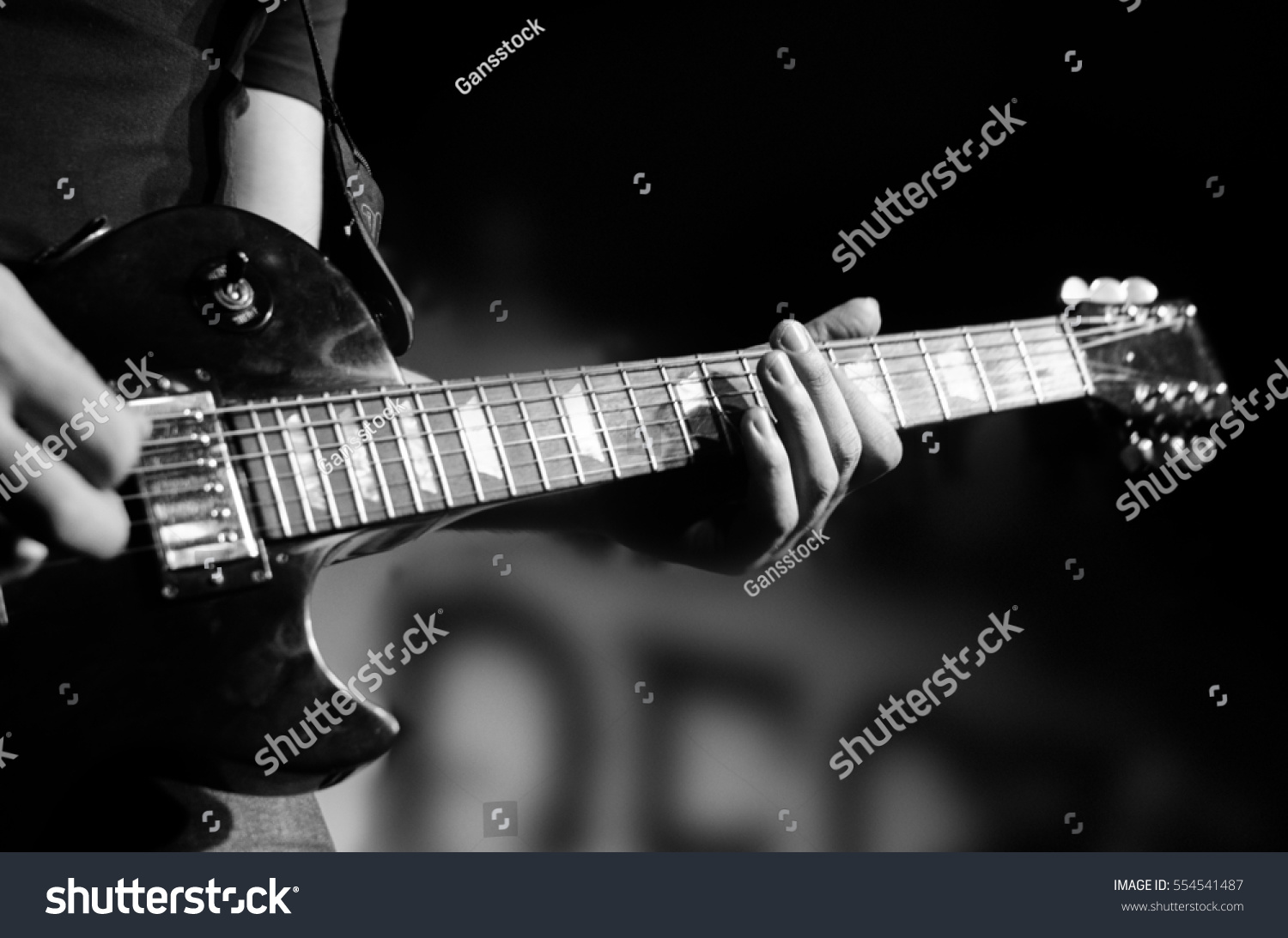 Guitar neck close-up on a concert of rock music in the hands of a musician #554541487