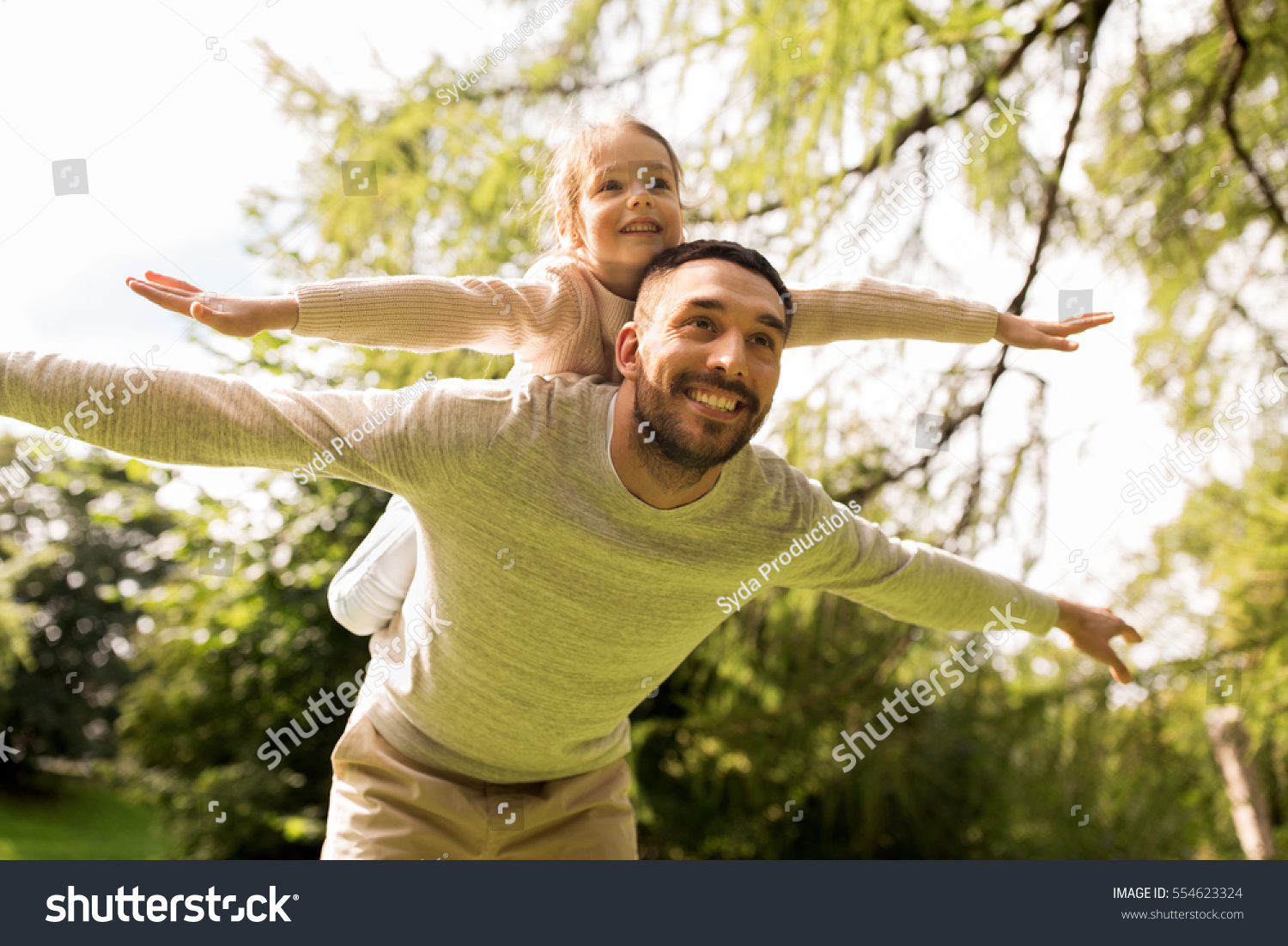 family, parenthood, fatherhood and people concept - happy man and little girl in having fun in summer park #554623324