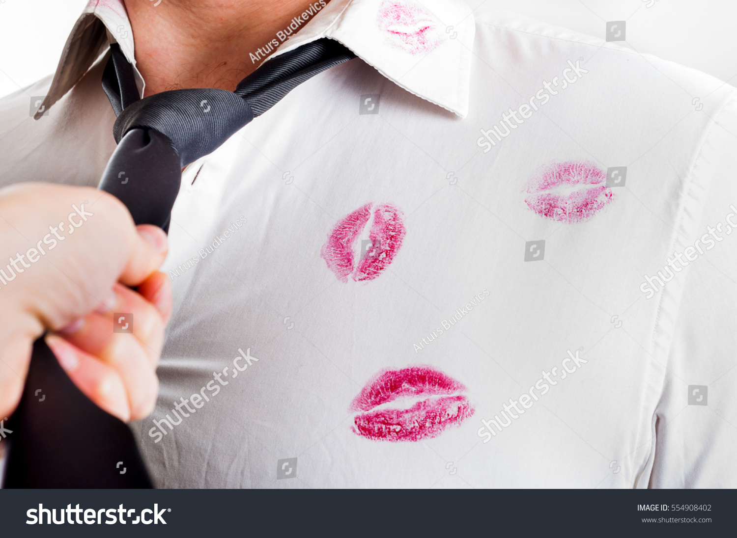 Man wearing white shirt covered by red lipstick kisses #554908402