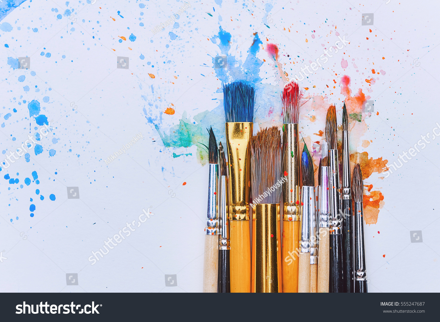 artistic brushes on wooden background #555247687