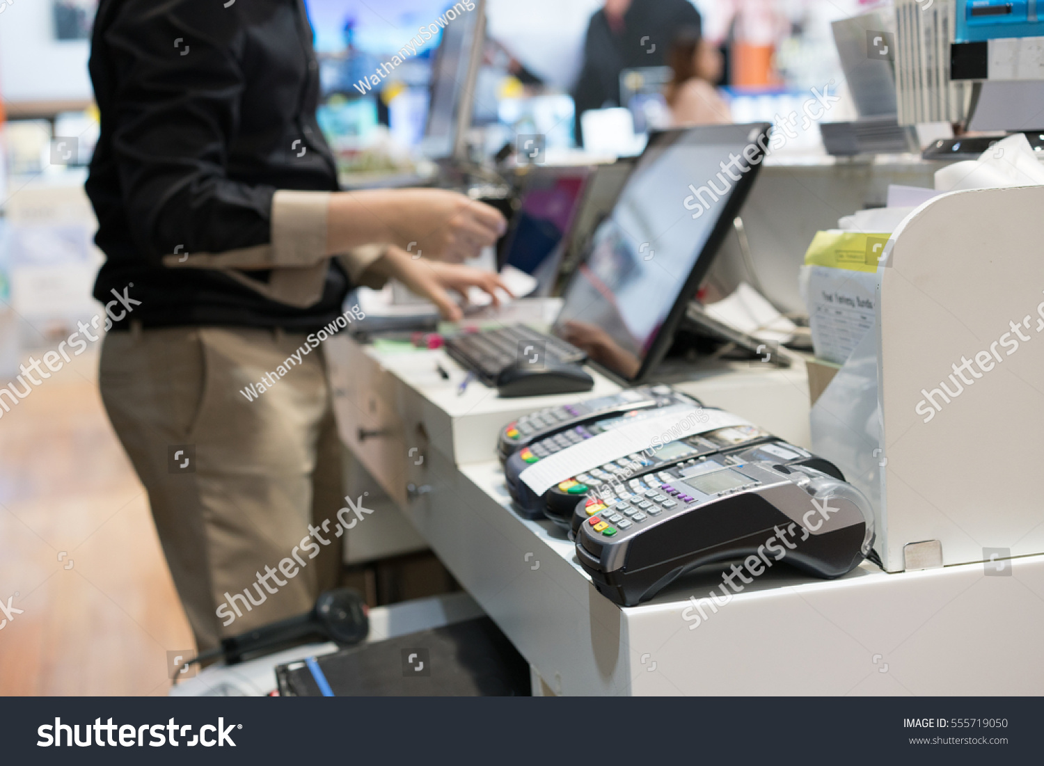 Man using pos terminal at the shop (paying credit card for purchases) #555719050