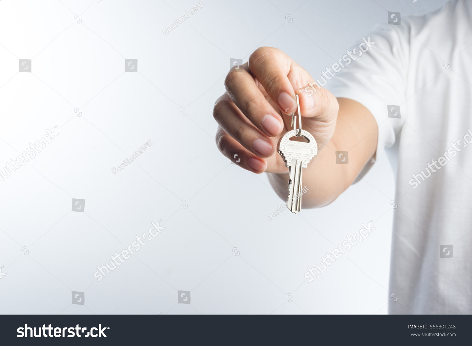 Hand giving keys on white background #556301248