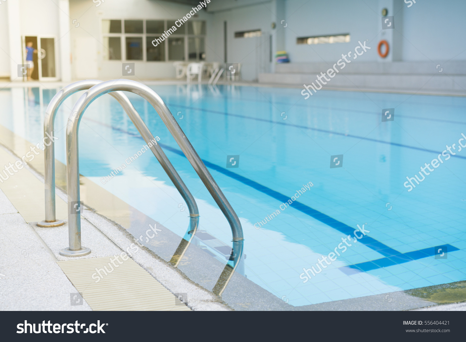 Indoor swimming pool with stair in a building #556404421